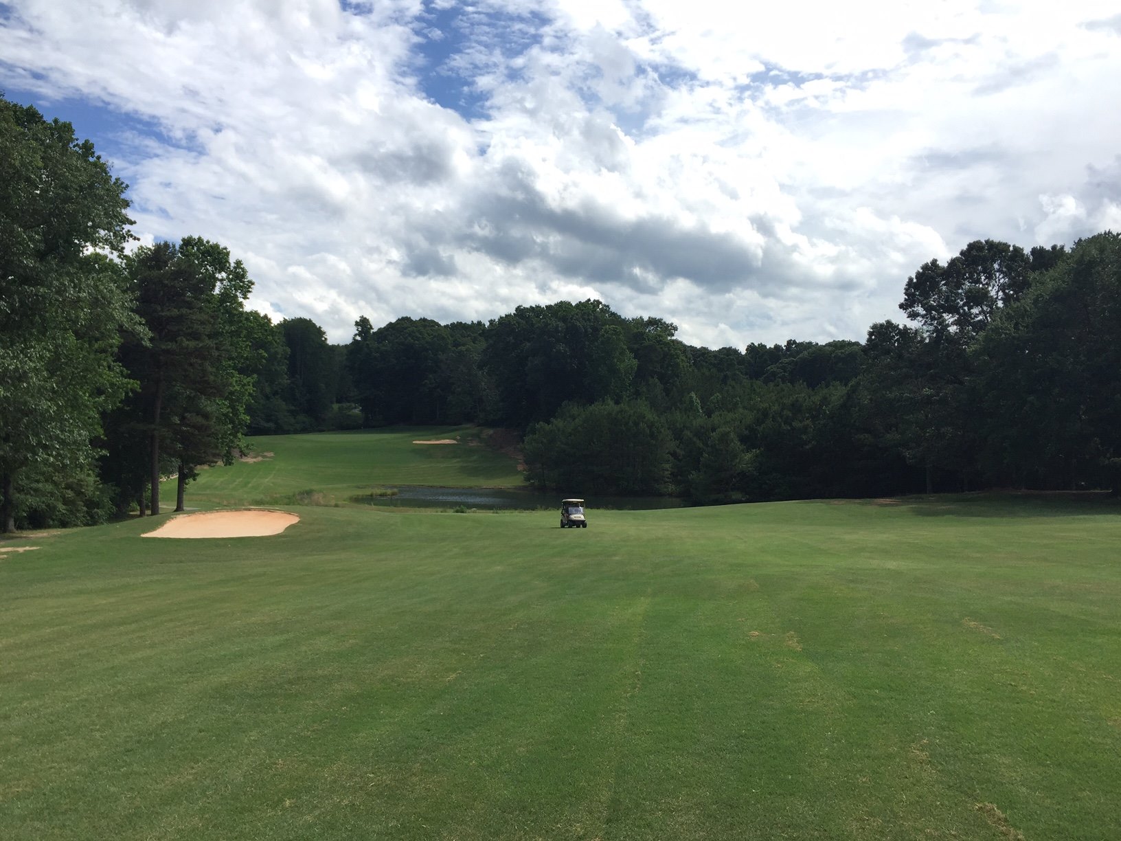 View of golf course green with bunker