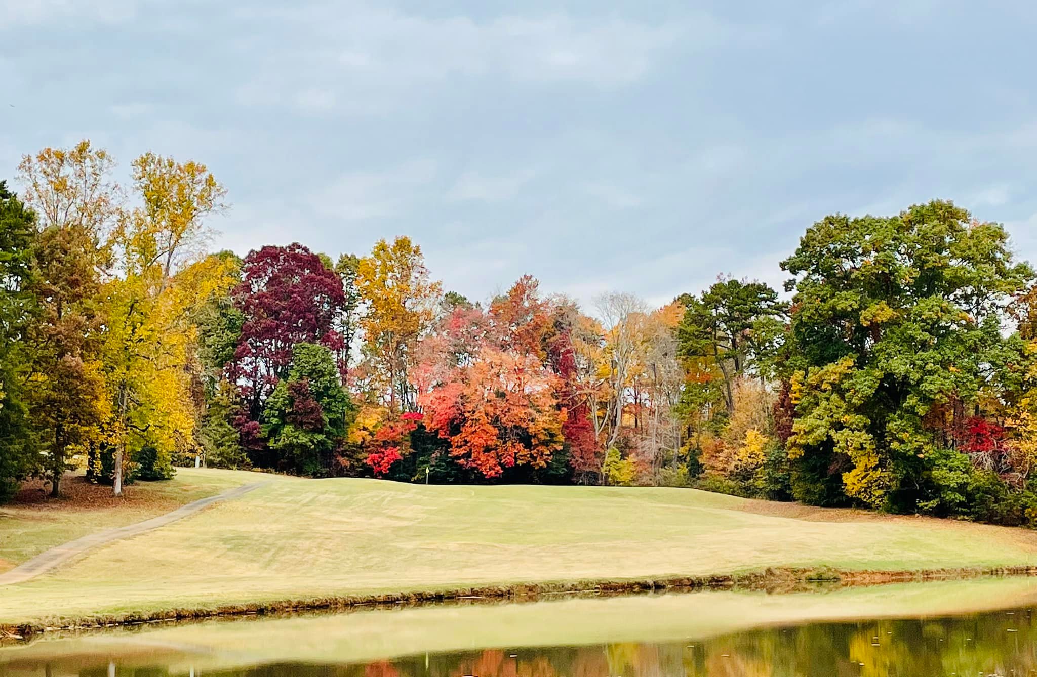 Golf course in autumn with colorful trees